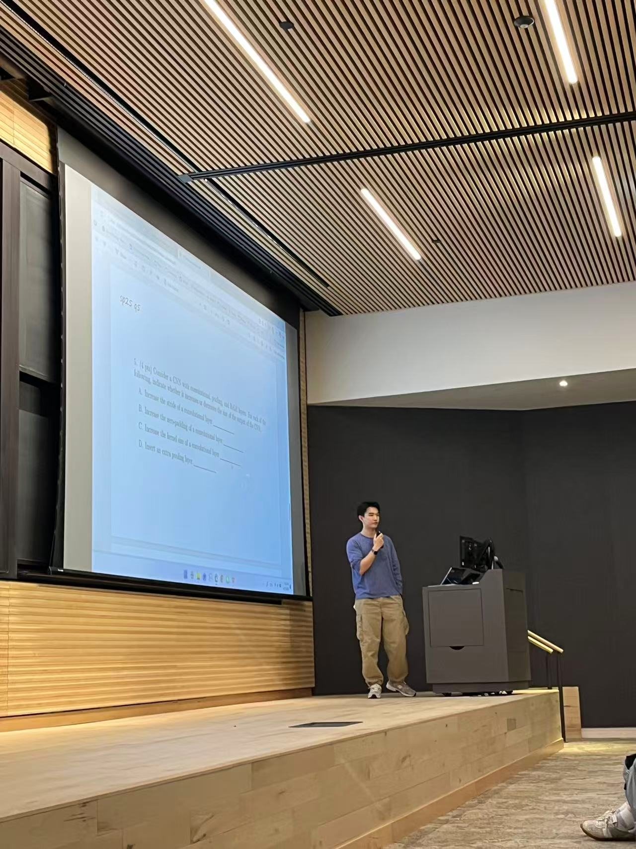 Zixun walking through a CNN review problem on a lecture hall screen